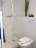 'Die Dusche mit flacher Wanne und die Toilette'